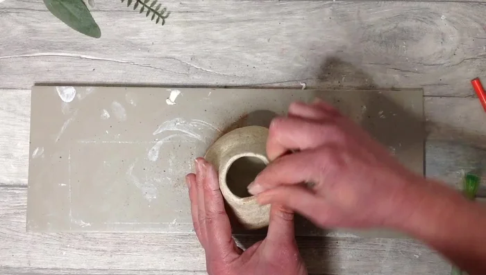 Pinch the edges to refine the vase's shape.