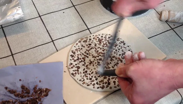 Pinch the sides of the clay to create a dish shape.