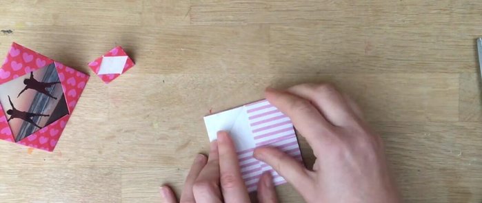 Fold up two opposite flaps: Fold one flap upwards, then the opposite flap upwards.