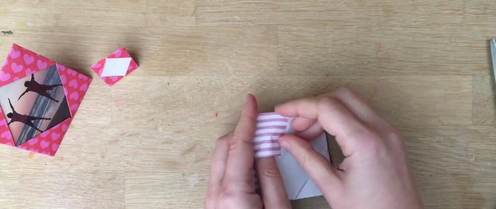 Tuck the flaps under: Tuck the folded flaps under the created creases to secure the frame.