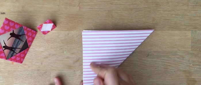 Create a diagonal fold: Fold the square in half diagonally, then unfold.