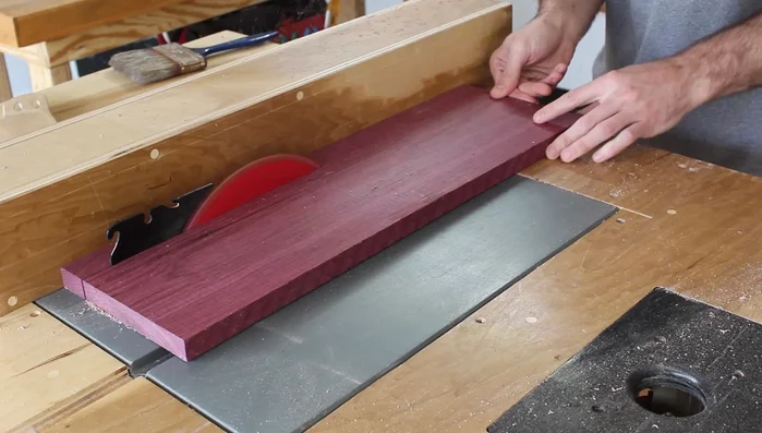 Ripping the wood to the desired cutting board thickness on the table saw.