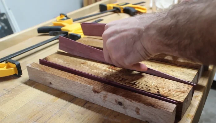 Inlaying Purple Heart wood (optional): Gluing and clamping the inlay pieces.