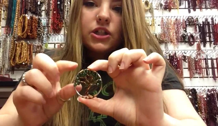 Trim and secure the wires: Angle the excess wires towards the center back of the tree, cut them with a flush cutter, and press down any remaining wire ends to prevent snagging. Attach a jump ring for hanging.