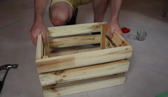 Adjust the crate to ensure it's square. Then add additional nails to all joints for added strength (two nails per slat on ends).