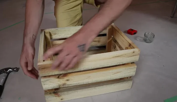 Adjust the crate to ensure it's square. Then add additional nails to all joints for added strength (two nails per slat on ends).