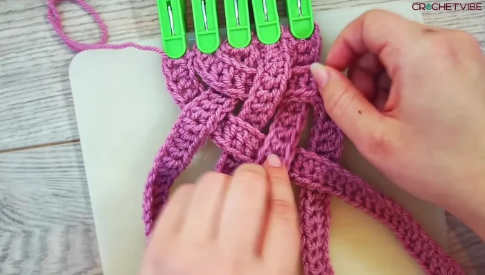 Continue braiding, keeping the strands taut and neat. The braiding pattern will be consistent once started.