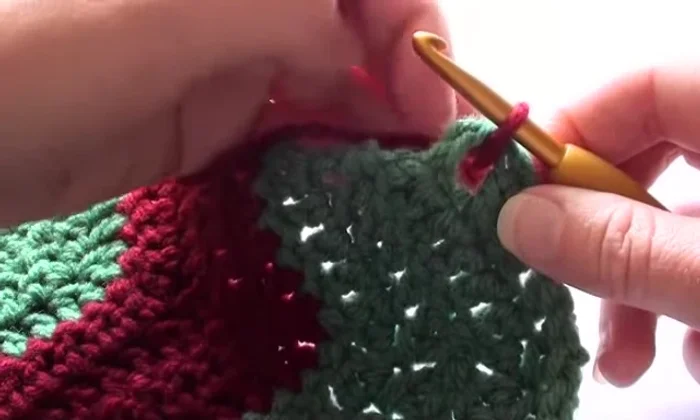 Work two single crochet stitches into the corner.