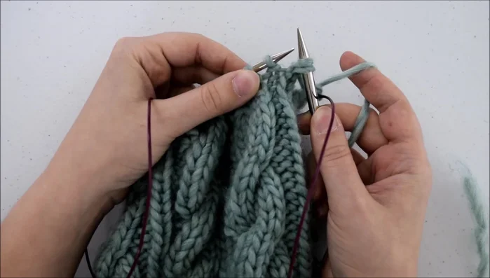 Pass the two slipped stitches over the stitch you just knit.