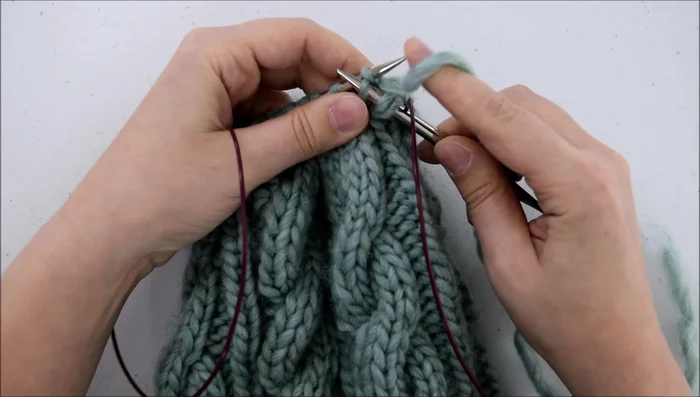 Pass the two slipped stitches over the stitch you just knit.