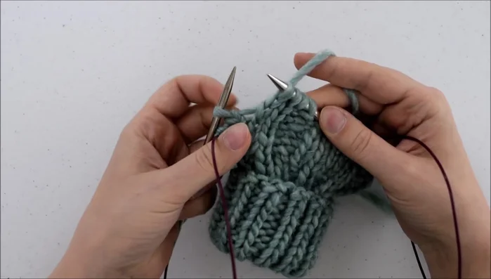 Knit through the front of that loop.