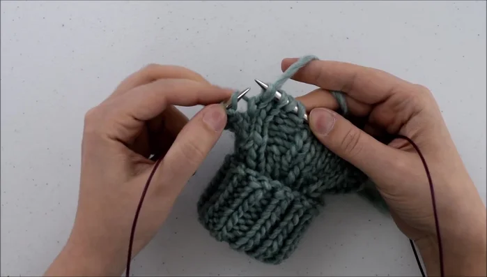 Knit through the front of that loop.