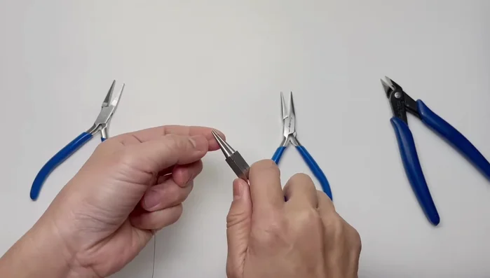 Wire wrap the chain closed. The number of wraps depends on the desired chain length and bead size. Check for equal wraps on both sides.