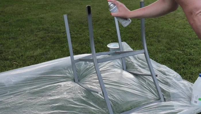 Refinish chair frames using Rust-Oleum paint and primer in flat black. Allow to dry completely.