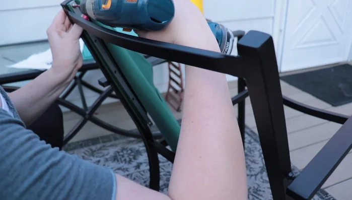 Attach the new fabric to the chair frame using the existing metal brackets and screws.