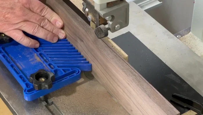 Cut 45-degree angles on the ends of the side pieces using the table saw and a crosscut slot, ensuring accuracy with a stop block.