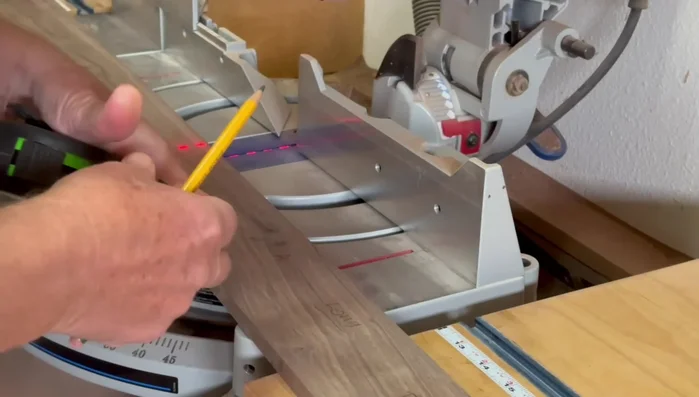 Cut 45-degree angles on the ends of the side pieces using the table saw and a crosscut slot, ensuring accuracy with a stop block.