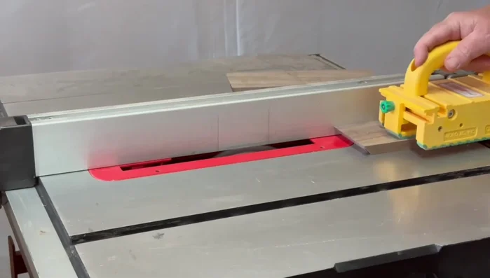 Cut the handle for the lid using the crosscut sled and a stop block (to prevent damage from the saw blade guard gap).