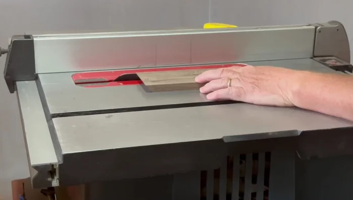 Cut the handle for the lid using the crosscut sled and a stop block (to prevent damage from the saw blade guard gap).