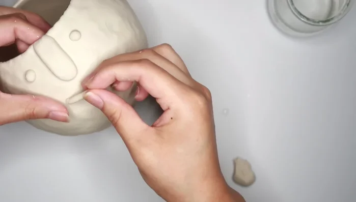 Sand the dried clay to smooth any imperfections.