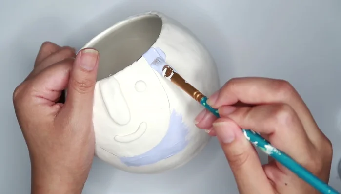 Paint the planter. Consider using different colors for the face and body.