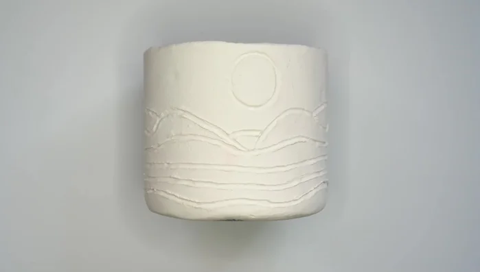 Sand the dried clay to smooth imperfections.