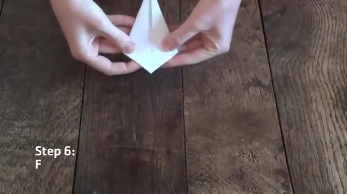 Fold down the top corner, creasing along the horizontal line created by the previous steps. Unfold.