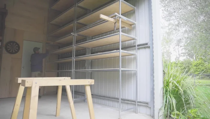 Construct a rail from 1-inch box section for the ladder to slide along. Add supports at each end and in the center.