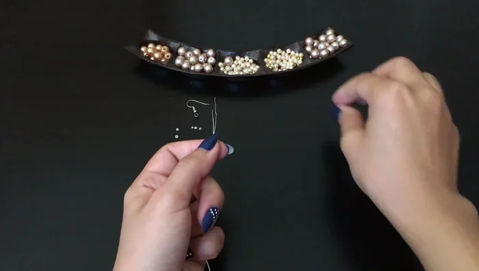 Create a loop of six small pearls on the back of the flower for attaching ear wires.