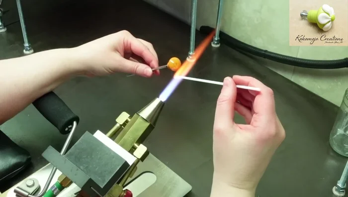 Decorate the knob (optional). For example, create a flower by placing and pressing down evenly spaced dots, then using a raking tool to create petals. Add a central dot and shape as desired. Add more heat to remove any chill marks.