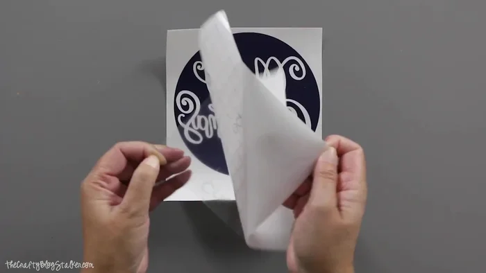 Apply transfer tape to the weeded vinyl, then carefully transfer the design to the back of the cleaned glass plate.