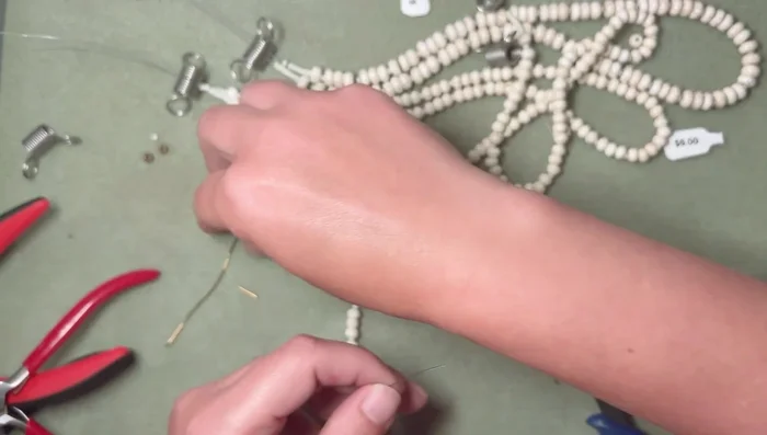 Add crimp beads to the wire end. Crimp using crimping pliers (folding the crimp bead from the back to the front).