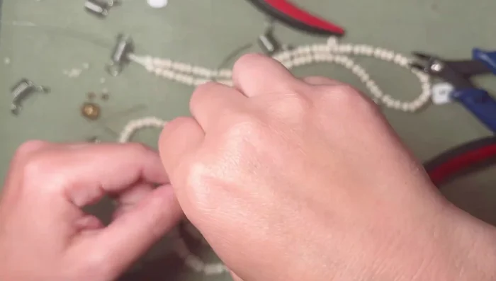 Assemble the strands together, arranging the larger bead strand in the center.