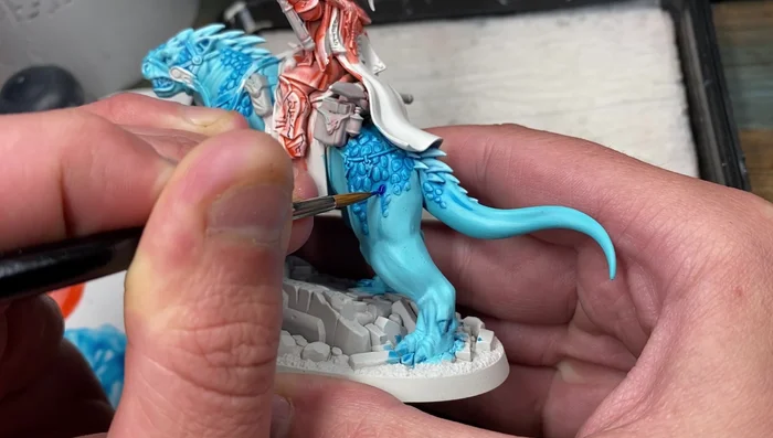 Apply Vallejo Model Color Blue to the scales, working the paint around the scales to avoid leaving gaps but being careful not to spill onto the skin.