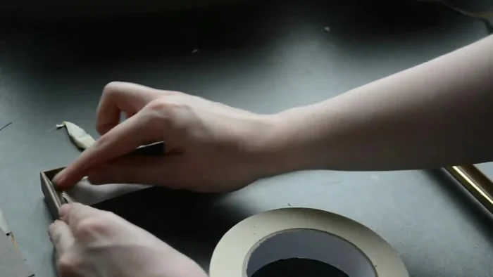 Mask gold edges on the frames and paint the frames black. Apply varnish for protection.