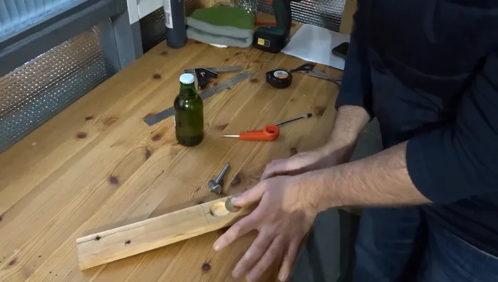 Drill a hole for the coin using a 30mm Forstner bit, matching the coin's diameter and thickness. Also, drill and countersink a hole in the center of the coin for a screw.
