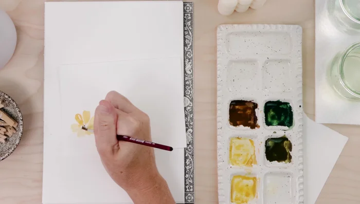 Add brown dots to the center of the flowers to create stamens.