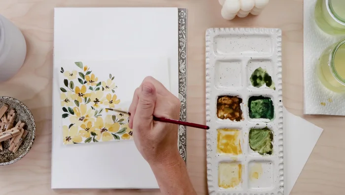 Add darker yellow to some petals for detail and fill in any remaining white space with small flowers or shapes.