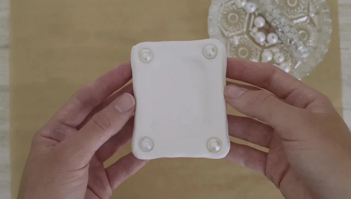 Decorate the frames (optional): Press beads into the clay.