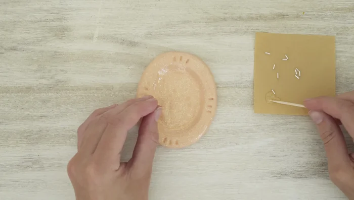 Glue beads back on: Use E6000 glue and a toothpick to carefully glue the beads back into place.