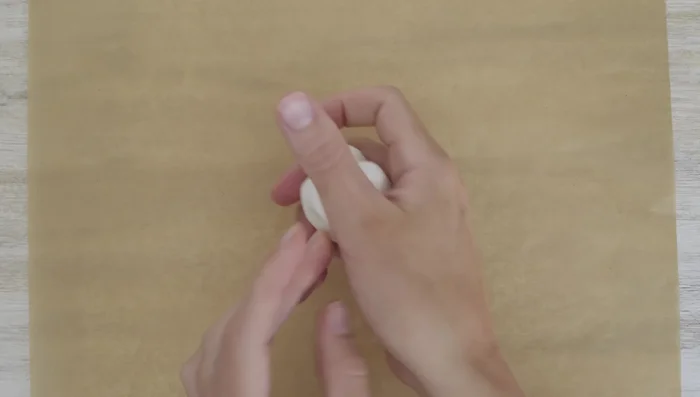 Prepare the clay frames: Roll a golf ball-sized amount of clay into a sphere, then shape it into a rectangle or oval. Use your finger to press an indentation inside the frame. Smooth out the edges.