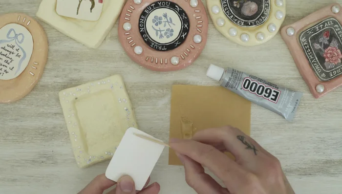 Glue the artwork into the frames: Use E6000 glue to attach the artwork to the back of the frame.