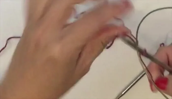 Cast on using a knitted cast-on for a stretchy edge. Start with a slip knot, cinch it onto your needle, and then create loops by inserting your needle into the loop, yarn around the right-hand needle, and pull up a loop, adding it to the left-hand needle. Repeat until you have the desired number of stitches (12 in this example).