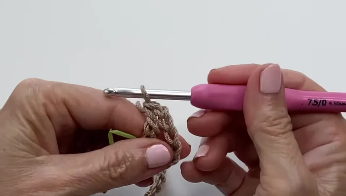 Round 1: Double crochet in the ninth chain from the hook, chain 2, skip 2 chains, double crochet in the third chain. Repeat across. End with a double crochet in the last chain.