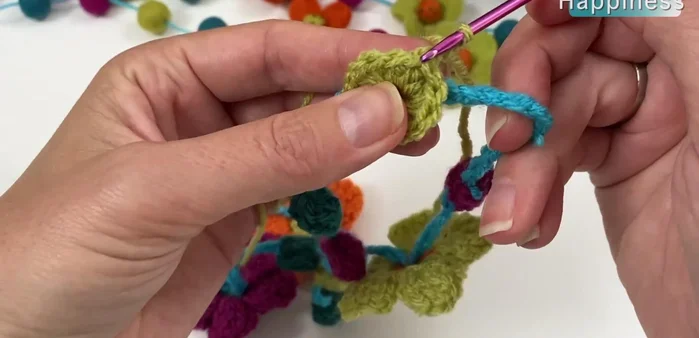 Create loops for the flower petals: chain 2, skip two stitches, slip stitch into the third. Repeat this process three times for each flower.