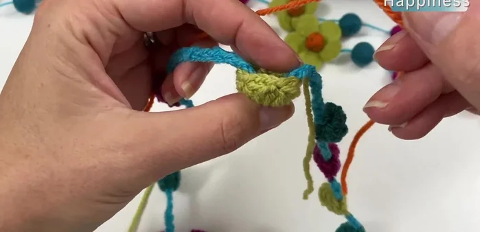 Repeat step 10 five times to complete the flower. Sew in ends and gently tighten the flower using a needle and yarn.