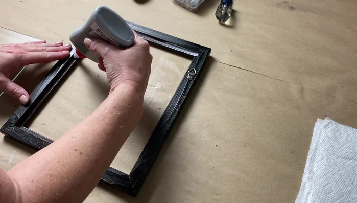 Glue the glass to the frame: Apply a line of Weld Bond around the inside of the frame opening and gently place the glass onto it. Add another line of Weld Bond along the glass edge where it meets the frame, ensuring a secure bond.