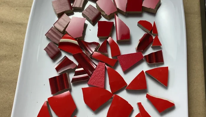 Gather your materials: Collect a variety of mosaic tesserae in different shapes, sizes, colors, and textures.