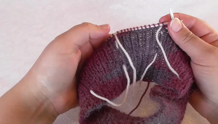 Place markers to separate sleeve stitches from the back and front pieces. Place a marker to indicate the front.