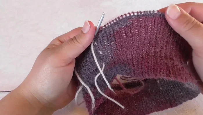 Place markers to separate sleeve stitches from the back and front pieces. Place a marker to indicate the front.